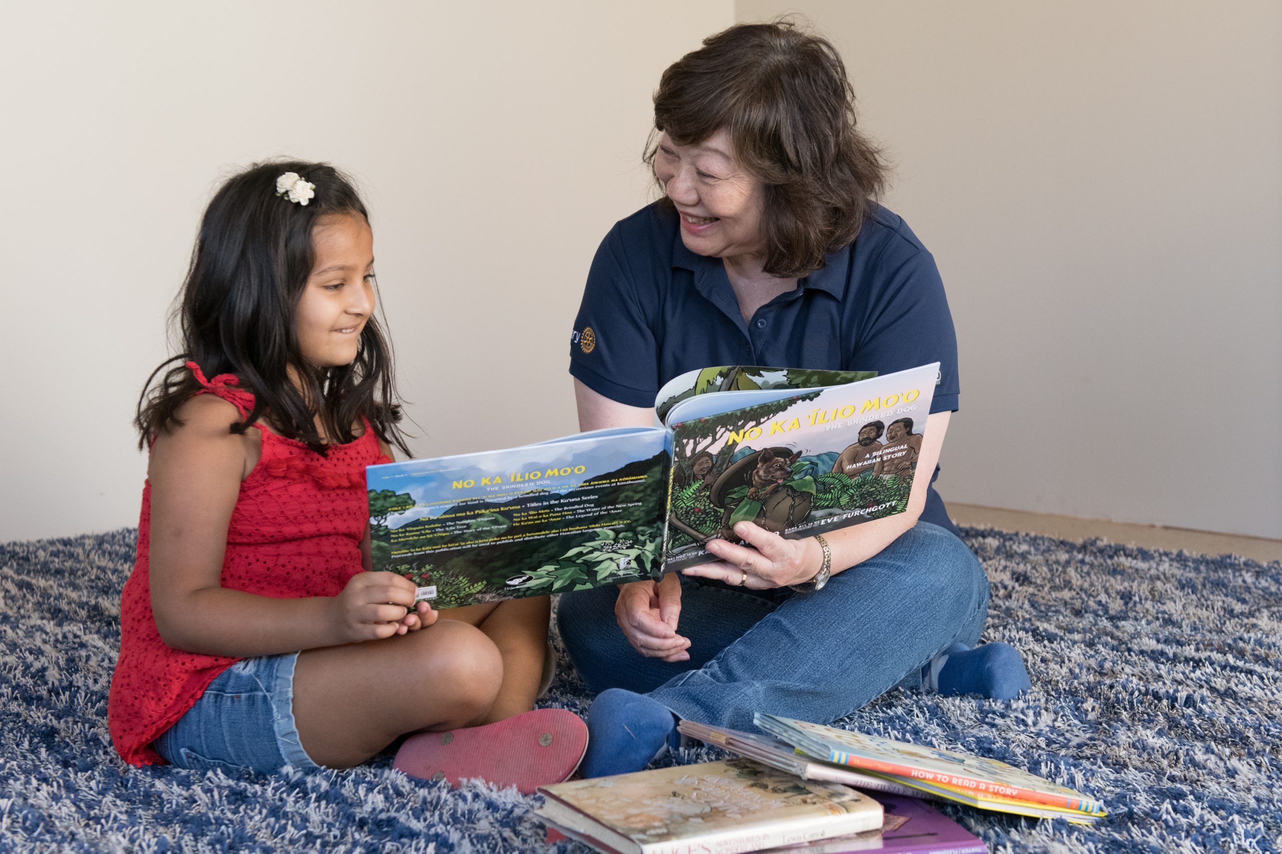 Woman reading a book to a child