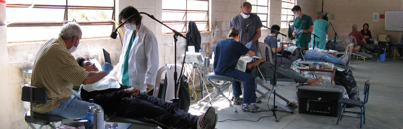 Dentists working at stations on people